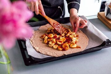 Close up view of baker is working. Homemade pie. Hands preparing dough on table. 