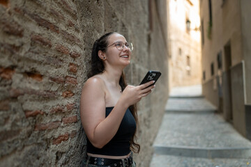 Tourist using smartphone in a narrow medieval street
