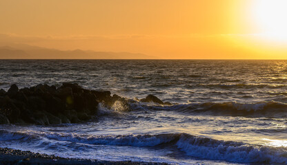 Fototapeta premium Golden sunset over the calm waters of the Mediterranean Sea in Cyprus.