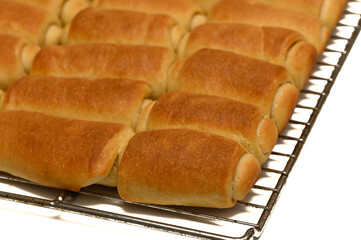 Fresh Parker House Rolls Cooling on Wire Rack at Home