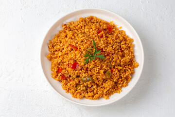 Traditional turkish bulgur pilaf with tomato sause in plate (Turkish name; meyhane pilavi)