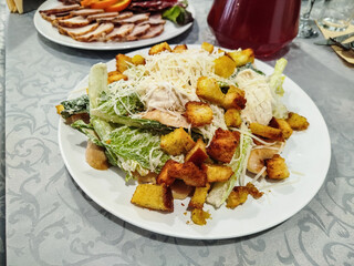 Caesar salad on white plate