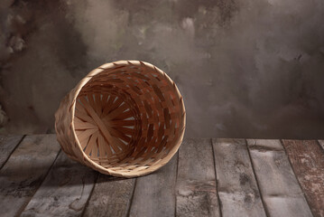 Empty basket, an empty straw basket on rustic wood with abstract background, selective focus.