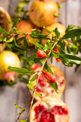 Pomegranates, arrangement with beautiful pomegranates on rustic wood with abstract background, selective focus.