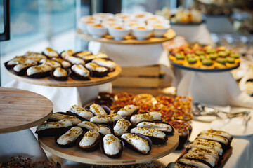 Assorted éclairs covered in chocolate on a festive table