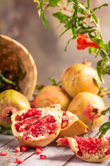 Pomegranates, arrangement with beautiful pomegranates on rustic wood with abstract background, selective focus.