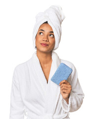 Young Filipino woman with sponge dreaming of achieving goals and purposes