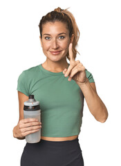 Blonde athlete with water bottle having an idea, inspiration concept.