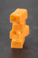 Vegan Apricot candy bar with pieces of dried apricots. Close-up. Dark background