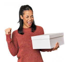 Young Filipina holding a box raising fist after a victory, winner concept.