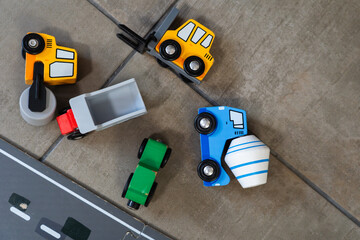 Obraz premium wooden construction toys next to a road on the floor at home