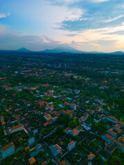 Rooftops of houses are surrounded by lush greenery in Ubud. Serene scenery of Ubud after sunset.