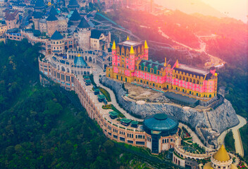 Sunset landscape aerial view of ba na hills lunar castles and French village wonders in Da nang,...