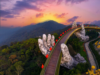 Aerial view Golden bridge at sunset in ba na hills two hands, Da nang Vietnam