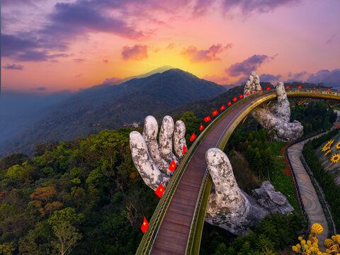 Aerial view Golden bridge at sunset in ba na hills two hands, Da nang Vietnam