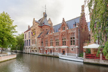 Historic architecture along a canal at dusk in summer. Bruges, Belgium.