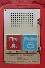 close up of a public emergancy call box for calling fire department or police in case of emergency with instructions to push button