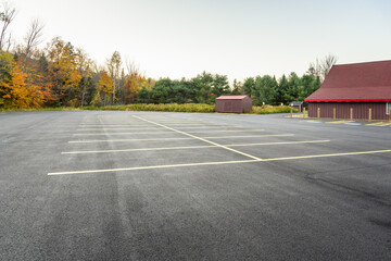 Deserted outdoor car park under clear sky at dusk in autumn