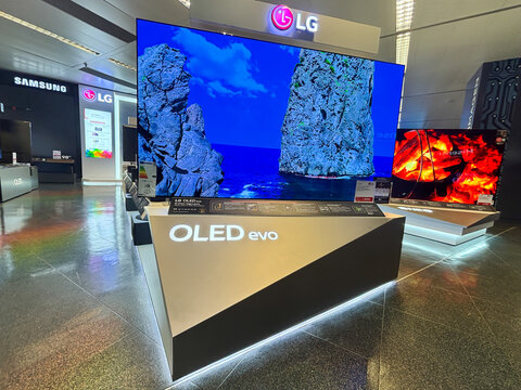 Alicante, Spain - June 11, 2025: LG OLED evo television displayed in a modern electronics store, showcasing vibrant colors and stunning image quality on a sleek stand