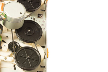 old tape recorder magnetic tape mechanism on white background. Close-up of magnetic tape feed mechanism. Copy space