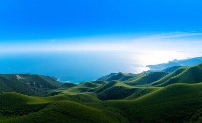 Obraz premium A breathtaking 4K aerial panorama reveals a tranquil coastal landscape where rolling green hills gracefully descend towards a serene blue expanse of water The horizon is dotted with distant sailboa