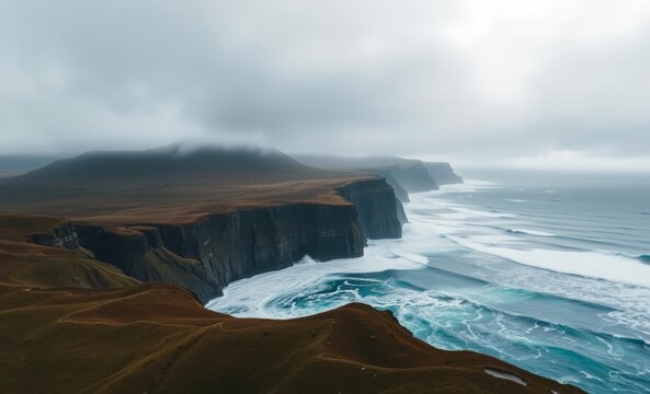 Iceland's rugged beauty unfolds in a breathtaking 4K drone image capturing a vast expanse of undulating hills meeting a dramatic cloud-laden coastline The ocean's raw power is evident in its relent