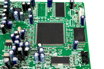A close-up of the processor microchip surrounded by other electrical components on a green circuit...