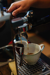 Close up of fresh espresso flows from coffee machine