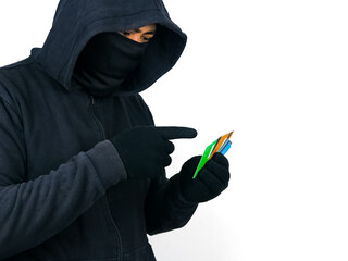 Cyber crime concepts. A male thief holds and pointing credit card in his hand and picks up a...