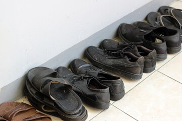Row of shoes and sandals in front of the room