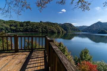 view of reservoir in mountain area from wood deck in Kumamoto prefecture, Japan.