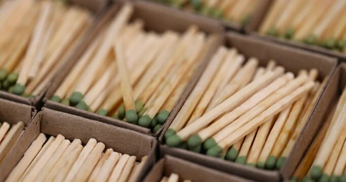 matches poured into boxes, a lot of wooden match laid out in cardboard matchbox