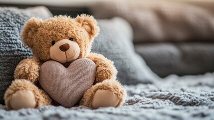 Cute teddy bear holding heart sits on cozy blanket in soft light