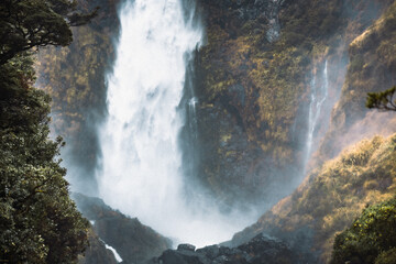 Looking at the base of a huge waterfall in New Zealand