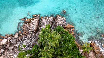 Island covered with lush greenery and jagged granite rocks. St Pierre Island. Seychelles.