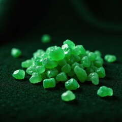 Green crystals scattered on a dark velvet cloth, green, glowing