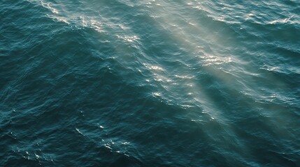 Obraz premium The calm sea, light blue-green tones, and the tranquil underwater view, where the sunlight reflects off the water's edge, creating a tranquil atmosphere. Gentle ripples and silence on the sea.