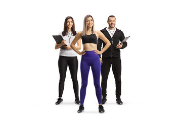 Male and female personal trainers with a young fit woman