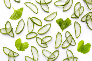 Fresh aloe vera slices and centella asiatica leaves on white background. Natural skincare ingredients