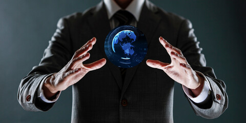 businessman holding a sphere with a globe in his hands.