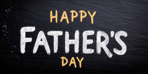 Happy Fathers Day message written in chalk style on blackboard background with warm and cheerful feeling for celebration