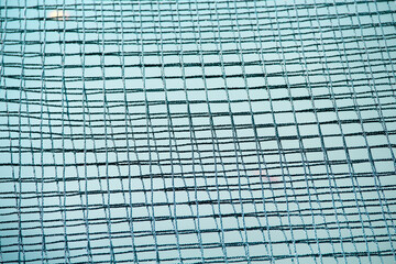 Black mesh string on blue water river abstract background