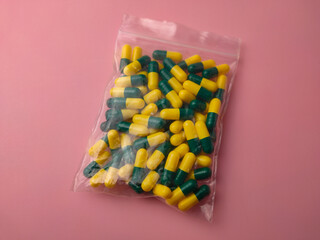 Closeup of a medicine pill package on a pink background