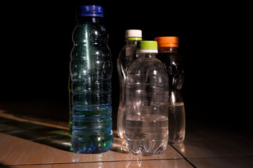 Crushed Plastic Bottle Trash Isolated on Dark Background – Environmental Waste Concept