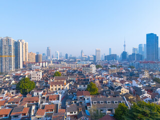 Aerial view of Shanghai modern buildings and traditional residential buildings on sunny day.
