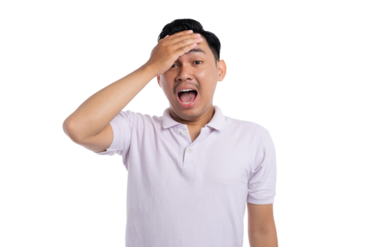 Surprised young man with hand on forehead and open mouth expressing shock isolated on transparent background
