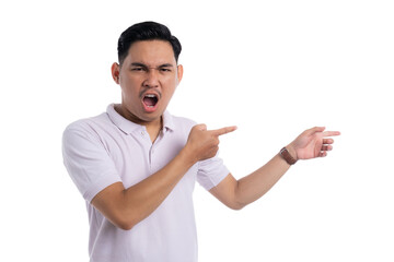 Angry young man shouting and pointing to the side with furious expression isolated on transparent background