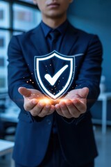 Businessperson holding a glowing shield symbol.