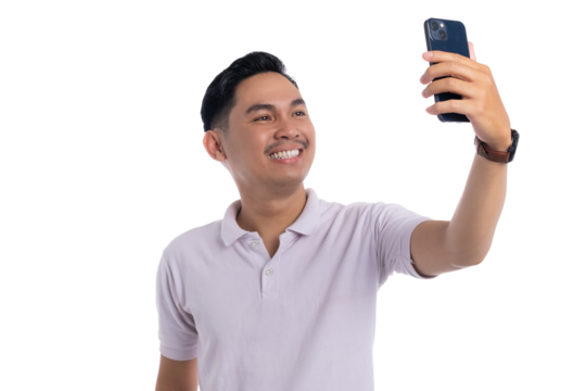 Happy young man taking selfie with smartphone while smiling and posing on transparent background