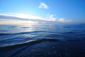 Serene Ocean View at Sunset with Clear Sky and Gentle Waves